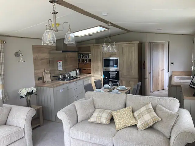 Living room with 2 sofas and big windows.