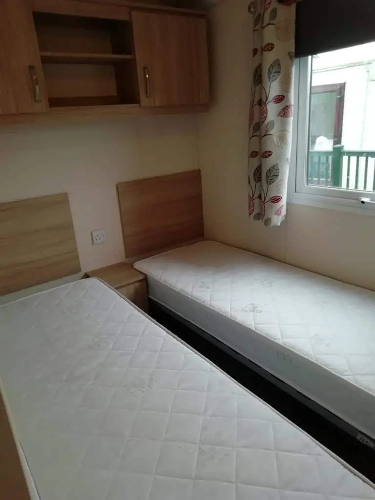 Europa Cypress 2 Europa Cypress twin bedroom with storage space and window.