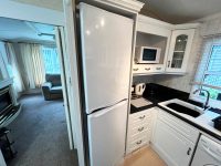 Atlas Sherwood Super 8 Compact modern kitchen in holiday caravan featuring full-size appliances and white fitted units