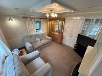 Atlas Sherwood Super 3 Comfortable living area in affordable static home featuring neutral decor and traditional furnishings
