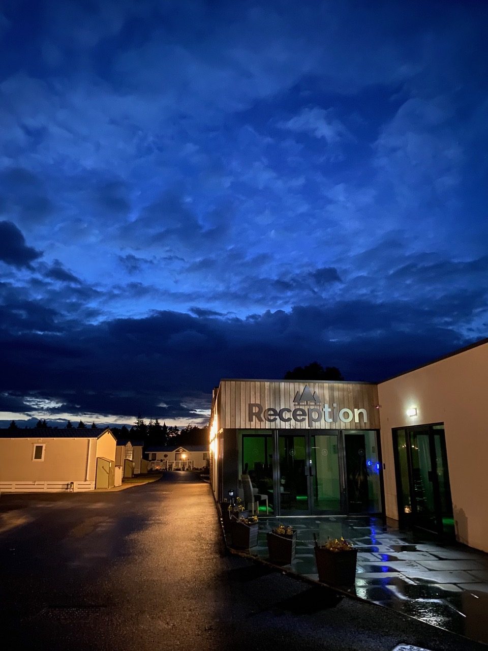 Night view of Heathergate holiday homes under a dramatic sky