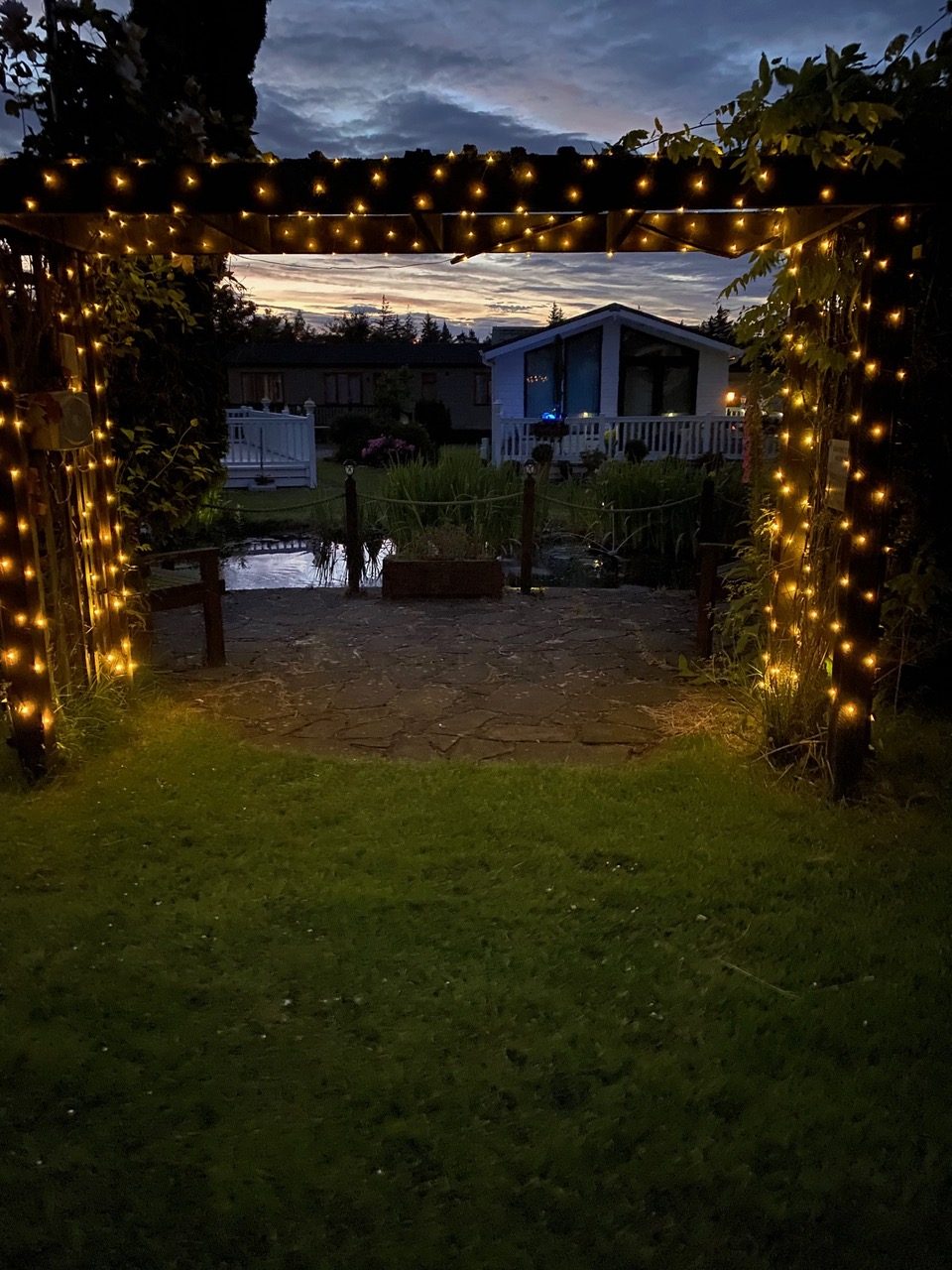 Festively lit archway leading to a holiday home at Heathergate