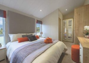 Double bed room, modern, orange accents. Investment Opportunity at Heathergate Boutique Holiday Park: Willerby Portland Lodge