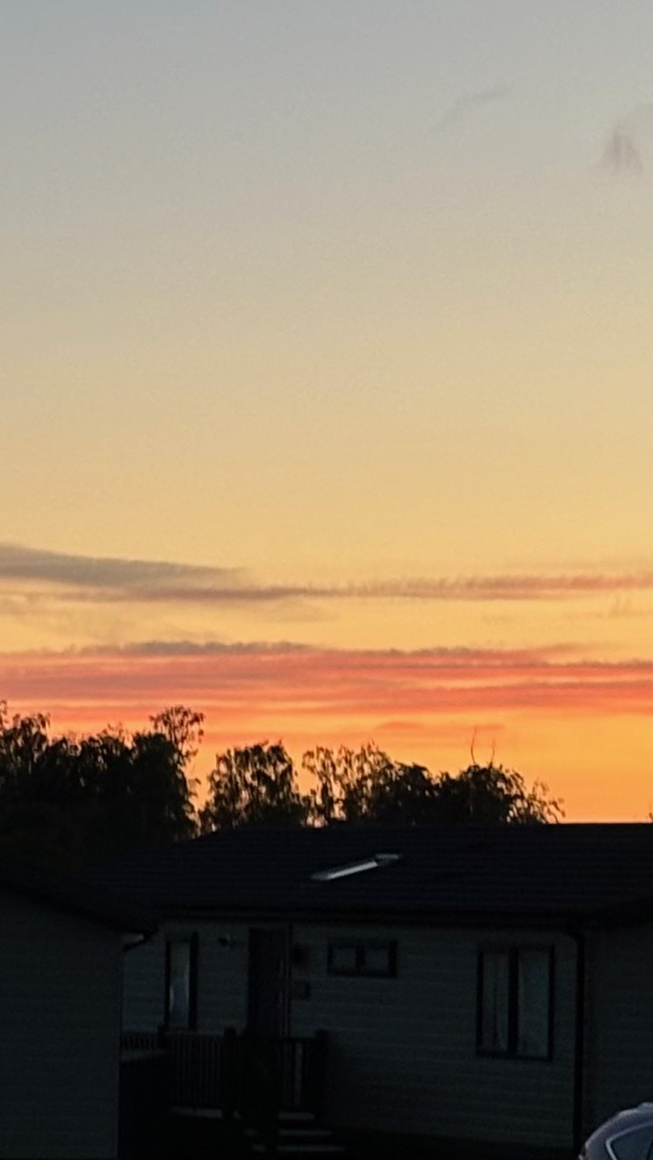 Silhouetted sunset view over holiday homes at Heathergate