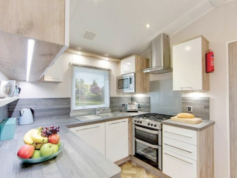 Modern, luxury well-equipped kitchen in a caravan holiday home.