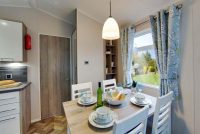 Willerby Canterbury 12 Modern kitchen and dining area in a holiday home with pendant lighting.