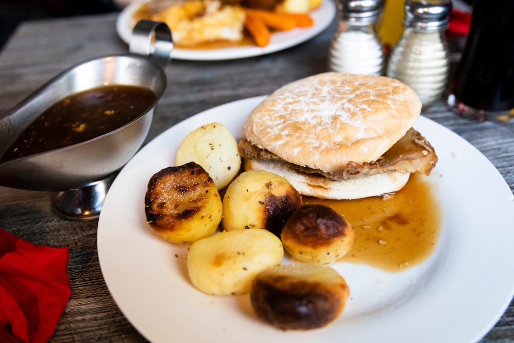 Traditional Northeast food a hot beef stottie with potatoes Beef stottie