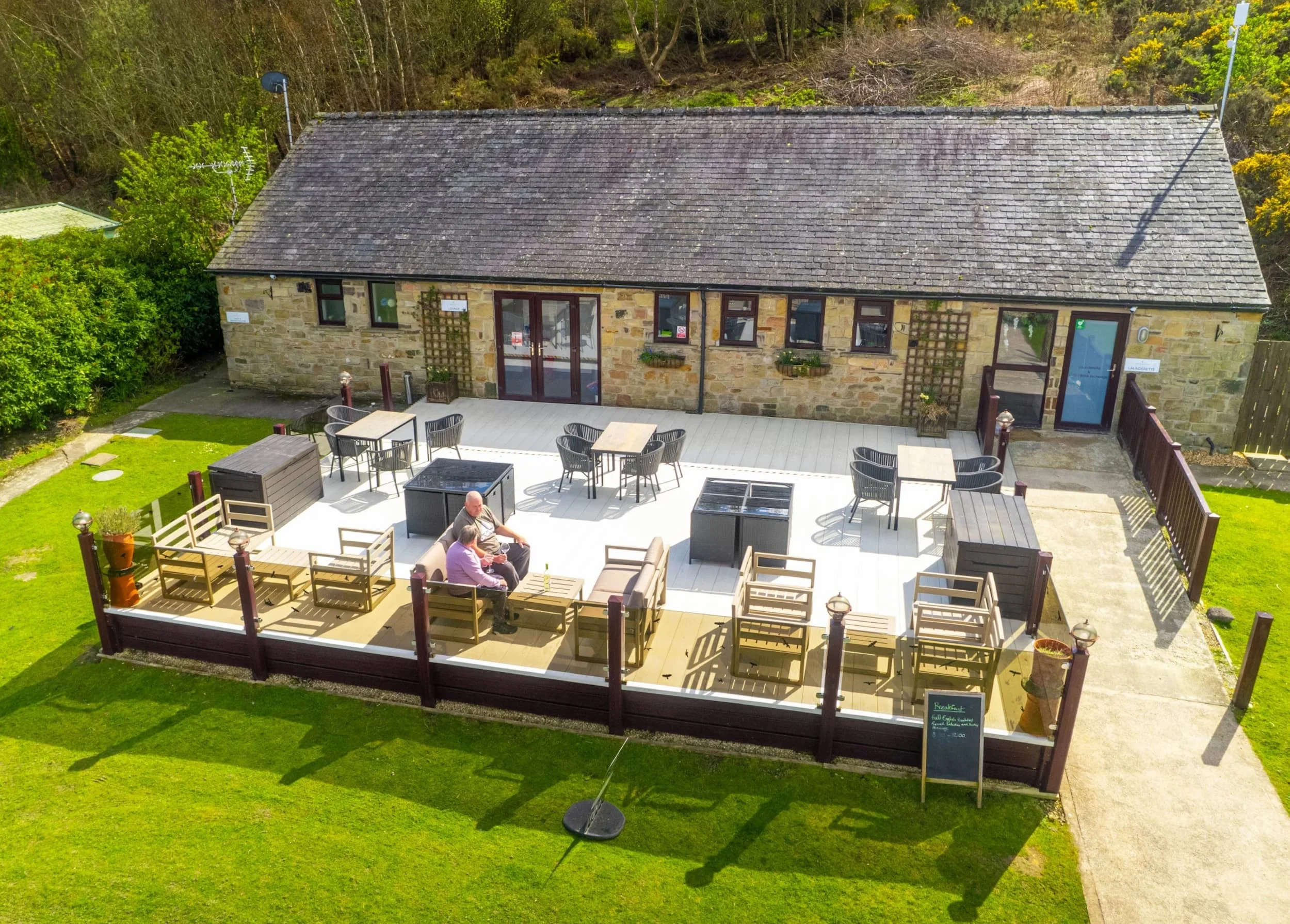Northumberland's Holiday Home Parks 16 Couple relaxing together on the sofa in a luxury lodge at Heathergate
