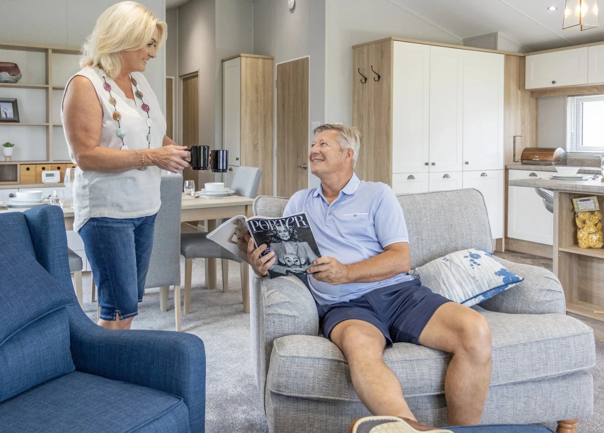 Northumberland's Holiday Home Parks 18 Couple enjoying their time in the kitchen area of a Heathergate lodge