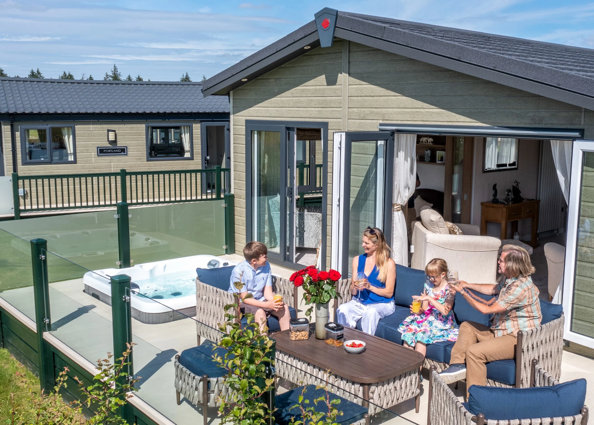 Northumberland's Holiday Home Parks 10 Family enjoying a hot tub at a luxury lodge at Heathergate